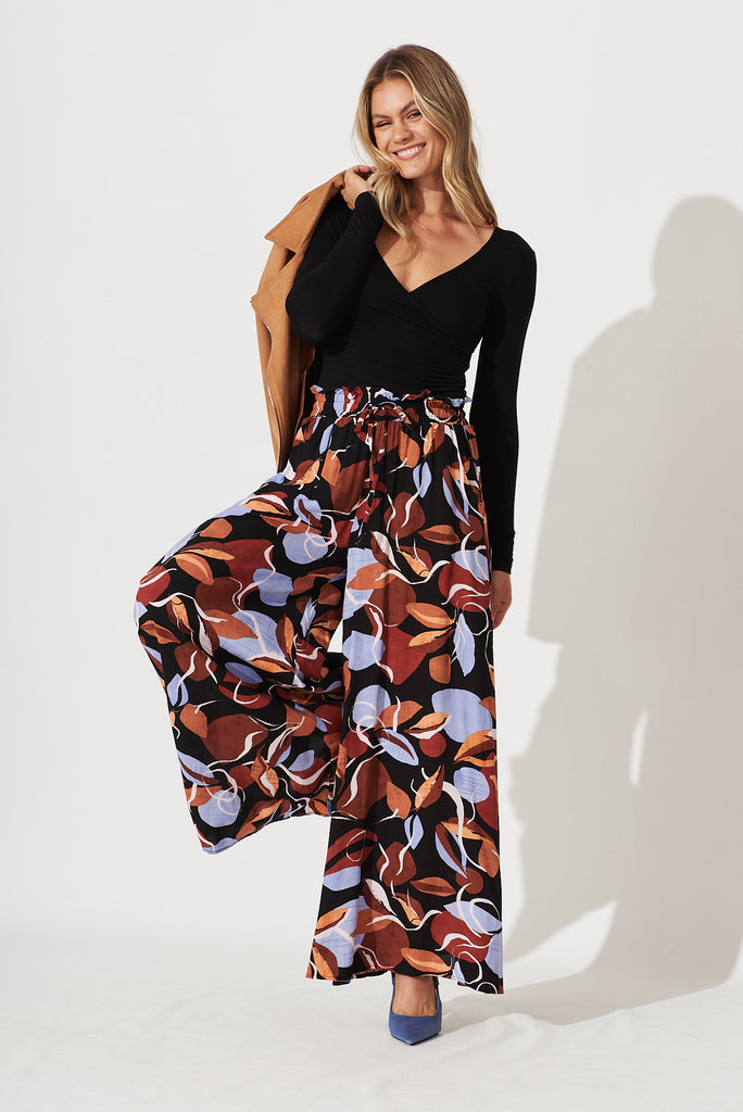 Mariah Pant In Black With Brown And Blue Leaf Print - full length